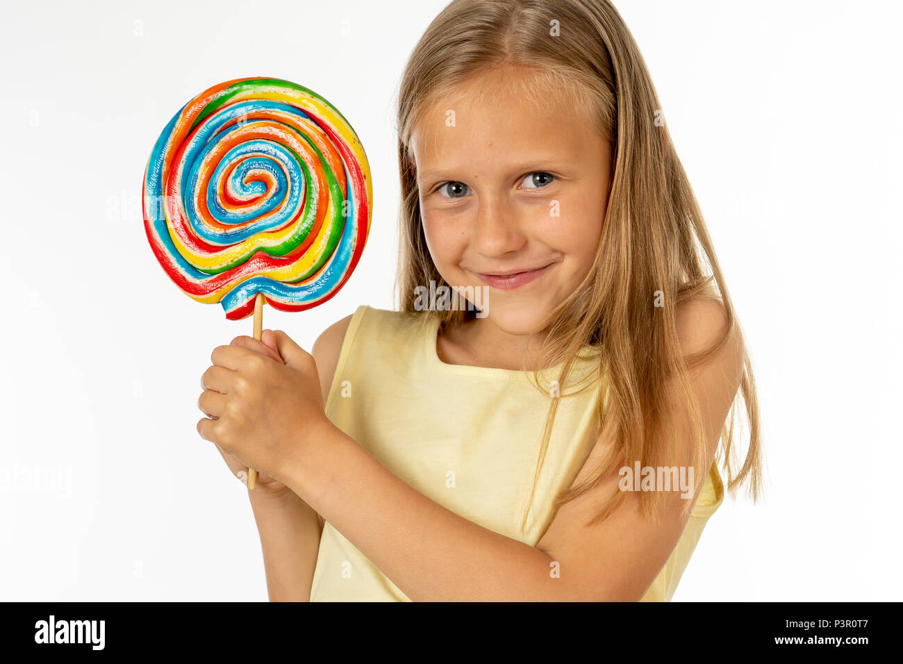 cute happy child with candy lollipop, happy girl eating big sugar lollipop, kid eat sweets. surprised child with candy. isolated on white background,  Stock Photo