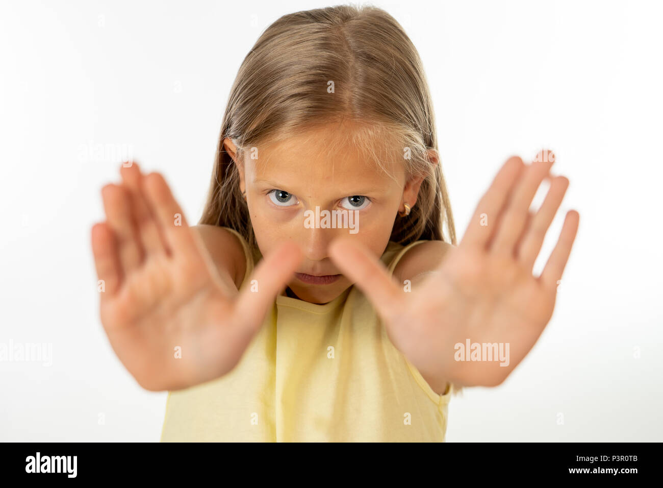 young cute schoolgirl scared, stressed and bulled looking desperate asking for help in victim children bullied abuse concept Stock Photo