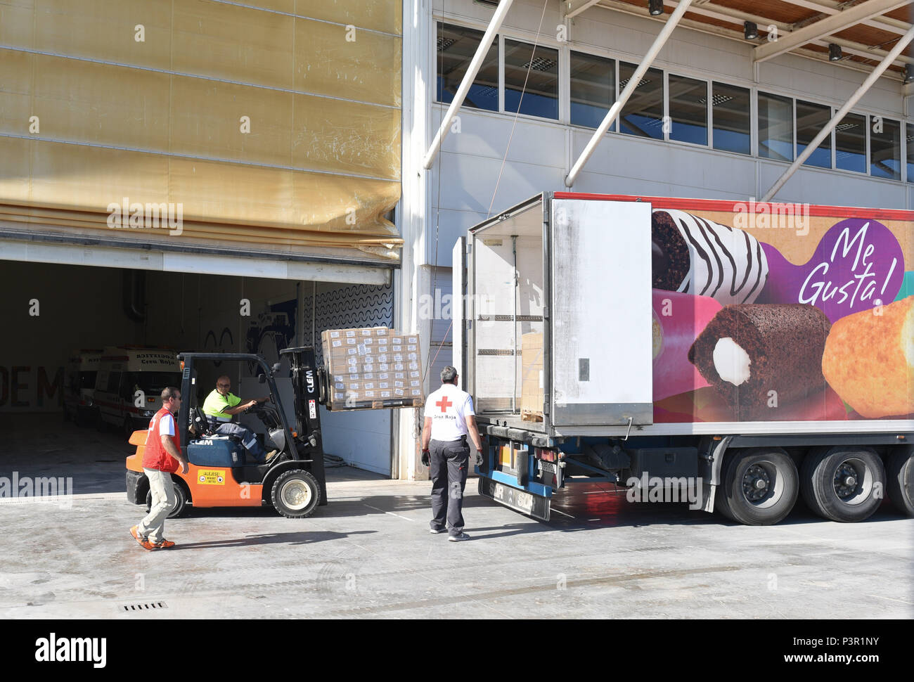June 15, 2018 - Valencia, Spain: Spanish Red Cross workers unload a truck carrying aid for migrants rescued by the Aquarius rescue ship, in a warehouse in the port of Valencia. The Aquarius migrant rescue ship is expected to dock in the port of Valencia this week-end after Italy and Malta rejected it. ***FRANCE OUT / NO SALES  IN SWEDEN, DENMARK, NORWAY, FINLAND BEFORE JUNE 25, 2018*** Stock Photo