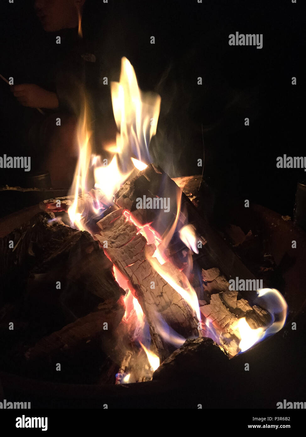 Outdoor Fire Burning Orange At Night With Glowing Logs Stock Photo