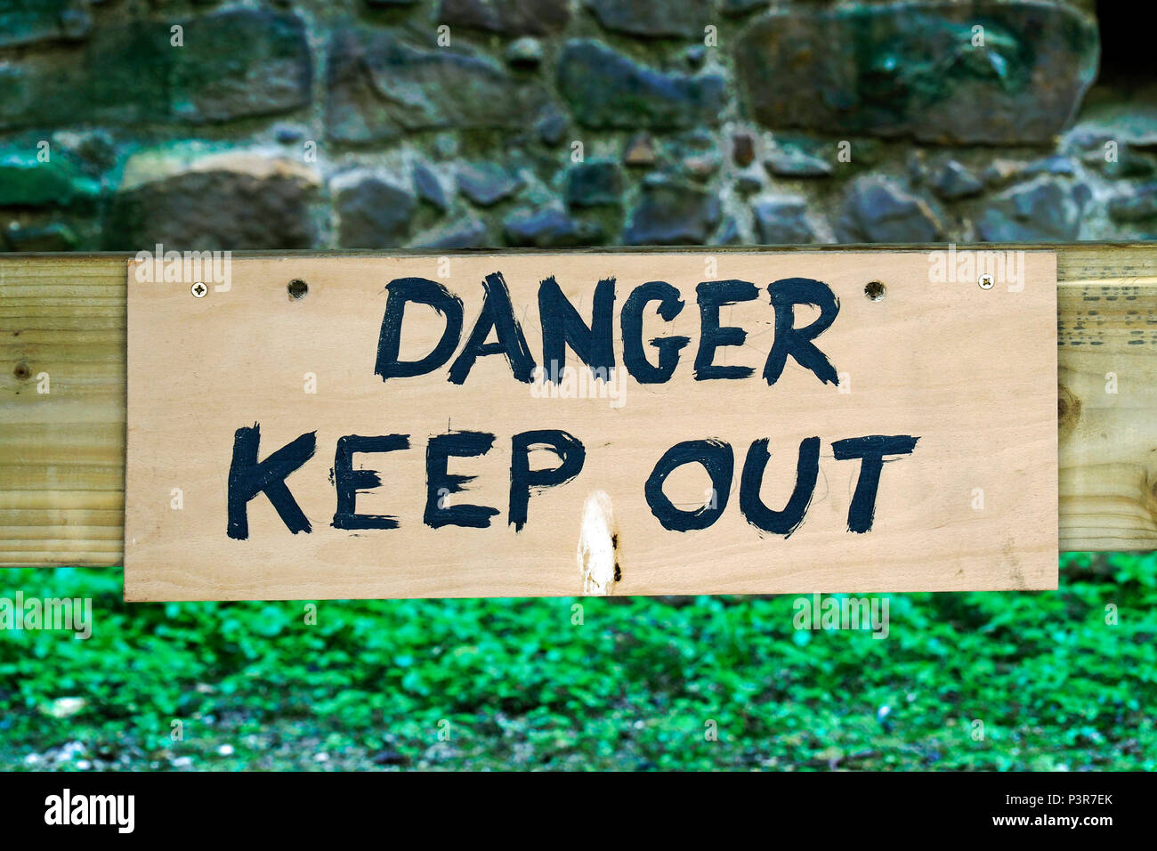 Hand painted Danger Keep Out sign in an old building, Stock Photo