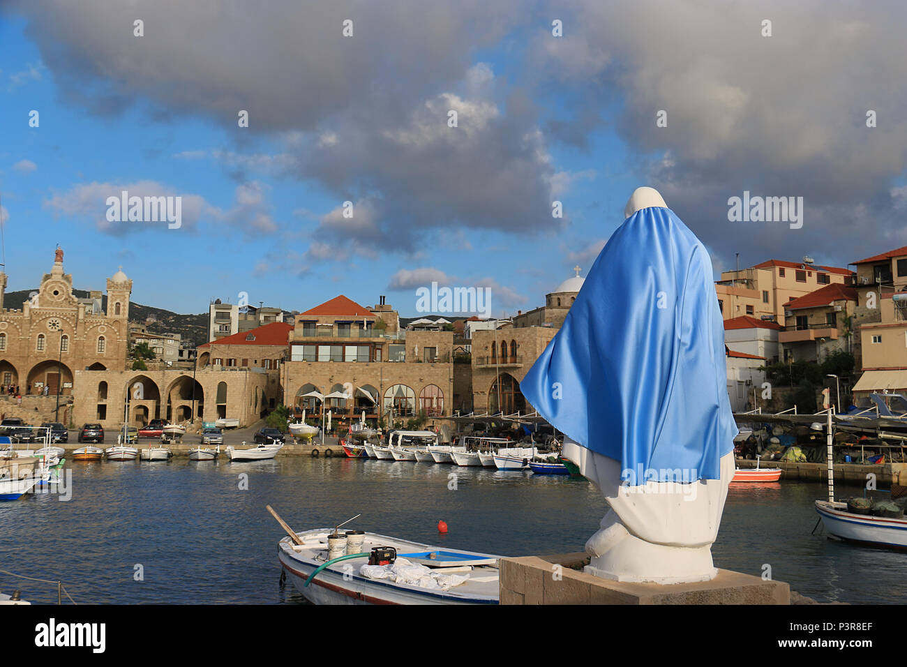 A white statue of the virgin with a blue cloth protecting the port of Batroun, Lebanon. Stock Photo