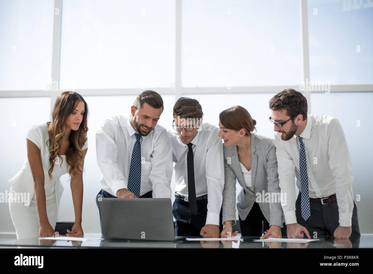 business team standing near the desktop Stock Photo - Alamy