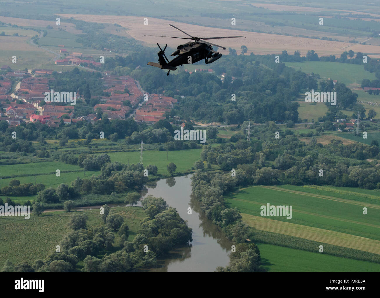 A UH-60 Blackhawk helicopter with Company C, 3rd Battalion, 501st Aviation Regiment performs flight maneuvers near the town of Voila, Romania, July, 29 during the Saber Guardian exercise that took place at the Romanian Land Forces Combat Training Center in Cincu, Romania. Saber Guardian is a multinational military exercise involving approximately 2,800 military personnel from ten nations including Armenia, Azerbaijan, Bulgaria, Canada, Georgia, Moldova, Poland, Romania, Ukraine and the U.S. (U.S. Army photo by Spc. Timothy Jackson, 115th Mobile Public Affairs Detachment, Oregon Army National G Stock Photo