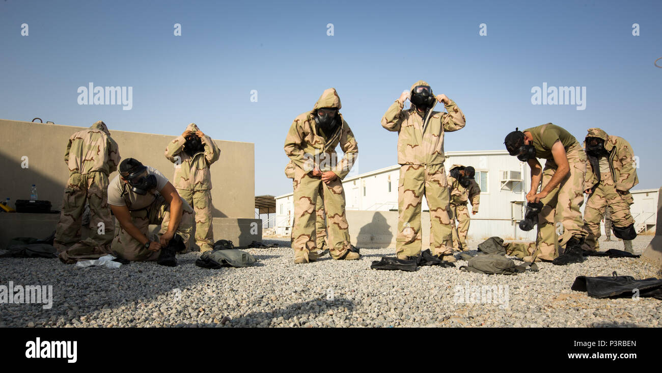 U.S. Marines with Special Purpose Marine Air-Ground Task Force - Crisis Response - Central Command, put on Mission Oriented Protective Posture gear during a Reconnaissance, Surveillance and Decontamination course run by Chemical, Biological, Radiological and Nuclear Defense Marines  while forward deployed, July 16, 2016. SPMAGTF-CR-CC is a crisis response unit that has the ability to project combat power throughout the Central Command area of responsibility, using organic aviation, logistical, and ground combat assets. (U.S. Marine Corps photo by Cpl. Trever Statz/Released) Stock Photo