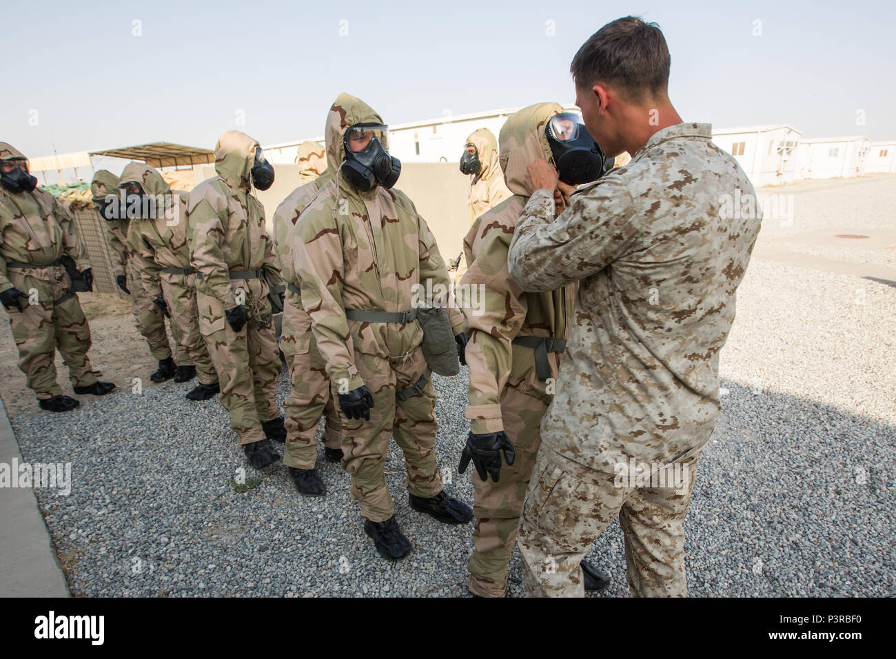 U.S. Marine Cpl. Travis Knigge, right, a Chemical, Biological, Radiological and Nuclear Defense specialist with Special Purpose Marine Air-Ground Task Force - Crisis Response - Central Command, inspects a Marine’s gas mask during a Reconnaissance, Surveillance and Decontamination course run by Chemical, Biological, Radiological and Nuclear Defense Marines while forward deployed, July 16, 2016. SPMAGTF-CR-CC is a crisis response unit that has the ability to project combat power throughout the Central Command area of responsibility, using organic aviation, logistical, and ground combat assets. ( Stock Photo