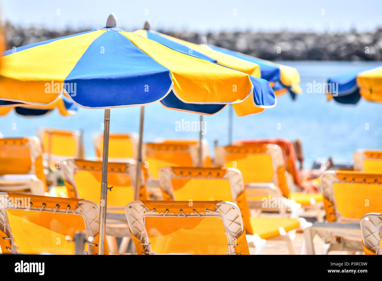 Sun umbrellas at sunny beach Stock Photo Alamy
