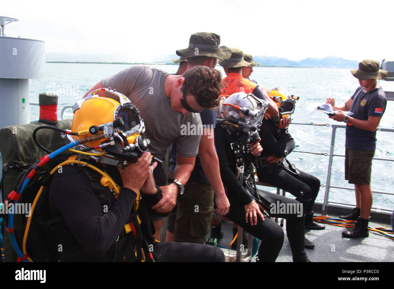 160726-O-GW536-002 PACIFIC OCEAN (July 26, 2016) Divers from Australian, Chinese and U.S. navies assist teammates in suiting up for a multinational salvage dive exercise aboard Chinese Navy submarine rescue ship Changdao (867) during Rim of the Pacific 2016. Twenty-six nations, more than 40 ships and submarines, more than 200 aircraft and 25,000 personnel are participating in RIMPAC from June 30 to Aug. 4, in and around the Hawaiian Islands and Southern California. The world's largest international maritime exercise, RIMPAC provides a unique training opportunity that helps participants foster  Stock Photo