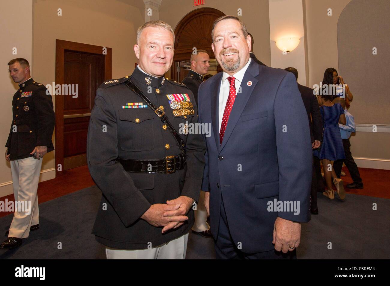 U.S. Marine Corps Lt. Gen. Kenneth F. McKenzie Jr., director, Strategic Plans and Policy, J-5, and Mr. Robert L. Simmons II, majority staff director, United States House Committee on Armed Services, pose for a photo during a reception prior to the evening parade at Marine Barracks Washington, Washington, D.C., July 8, 2016. Evening parades are held as a means of honoring senior officials, distinguished citizens and supporters of the Marine Corps. (U.S. Marine Corps photo by Lance Cpl. Kayla V. Staten) Stock Photo