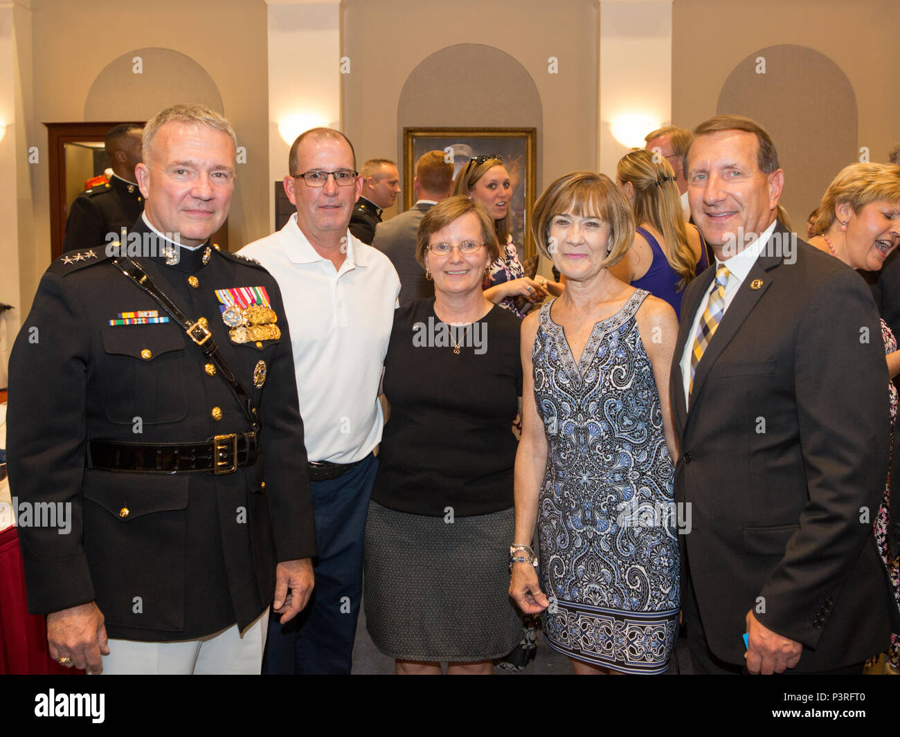 U.S. Marine Corps Lt. Gen. Kenneth F. McKenzie Jr., director, Strategic Plans and Policy, J-5, poses for a photo with family during a reception prior to the evening parade at Marine Barracks Washington, Washington, D.C., July 8, 2016. Evening parades are held as a means of honoring senior officials, distinguished citizens and supporters of the Marine Corps. (U.S. Marine Corps photo by Cpl. Christian J. Varney) Stock Photo