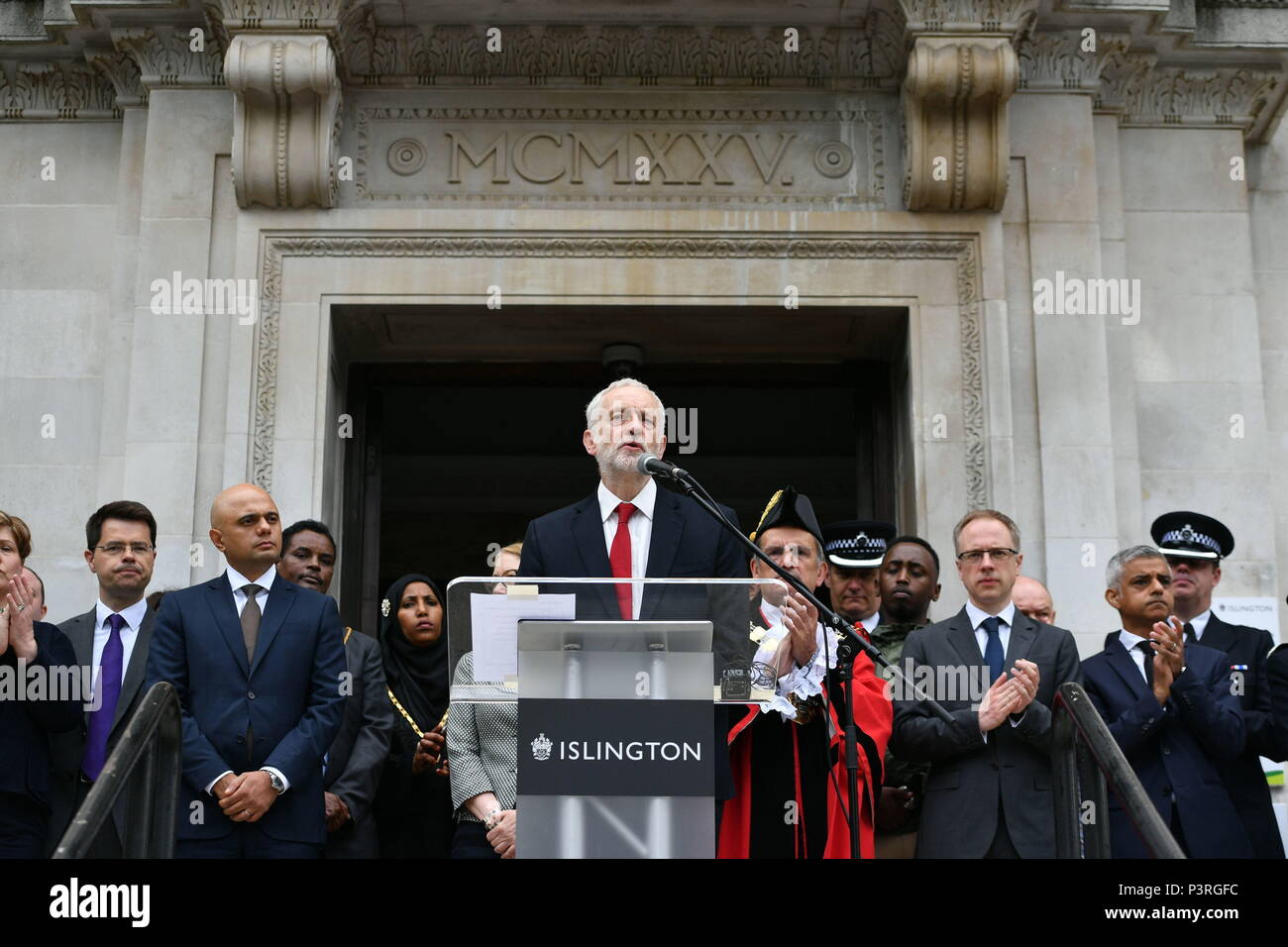 Jeremy Corbyn (centre) is watched by James Brokenshire (left), Sajid Javid (second left) and Sadiq Khan (right), as he speaks at Islington Town Hall in London to mark one-year anniversary of the Finsbury Park attack. Stock Photo