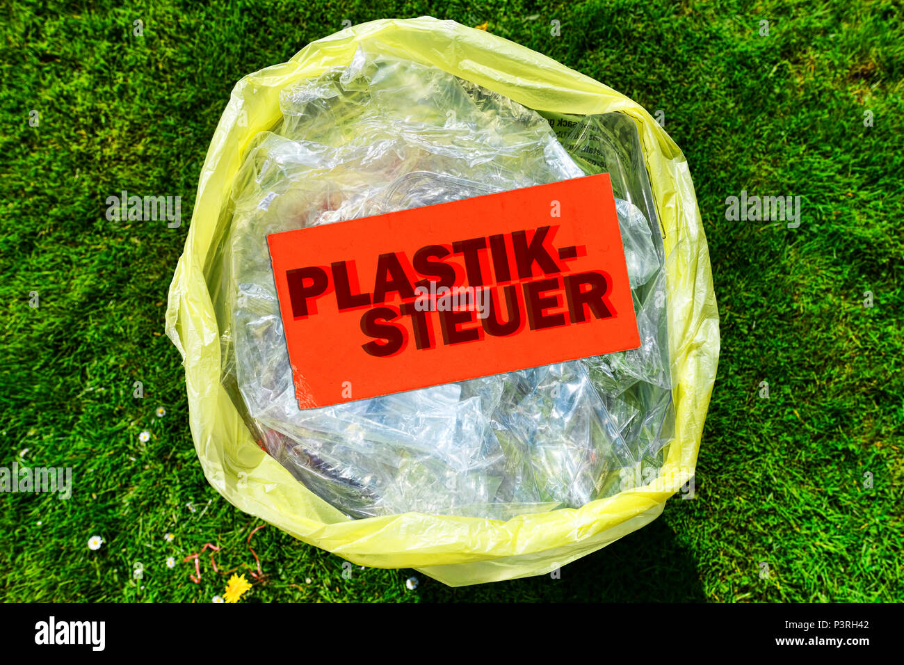 Plastic packaging waste and price tag labeled plastic control, Verpackungsmüll aus Kunststoff und Preisschild mit der Aufschrift Plastiksteuer Stock Photo