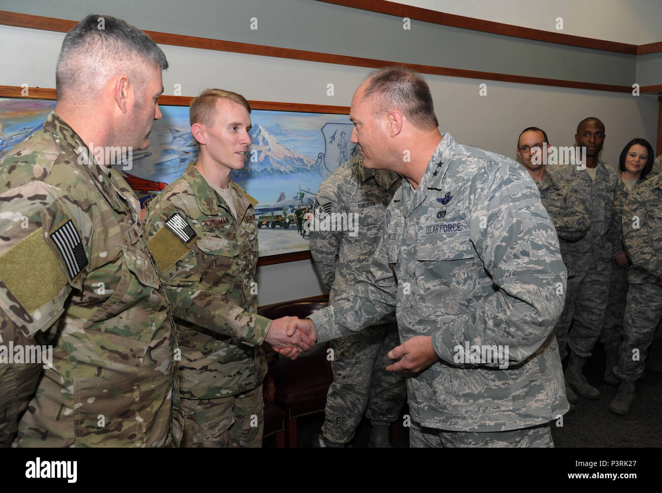 Staff Sgt. Christopher Couchman, assigned to the 125th STS, 142nd Fighter Wing Is ‘Coined’ by Maj. Gen. Michael Stencel, The Adjutant General of Oregon, as he recognizes select airmen for their recent accomplishments and diligence of duty, July 12, 2016, Portland Air National Guard Base, Ore. (U.S. Air National Guard photos by Tech. Sgt. John Hughel, 142nd Fighter Wing Public Affairs) Stock Photo