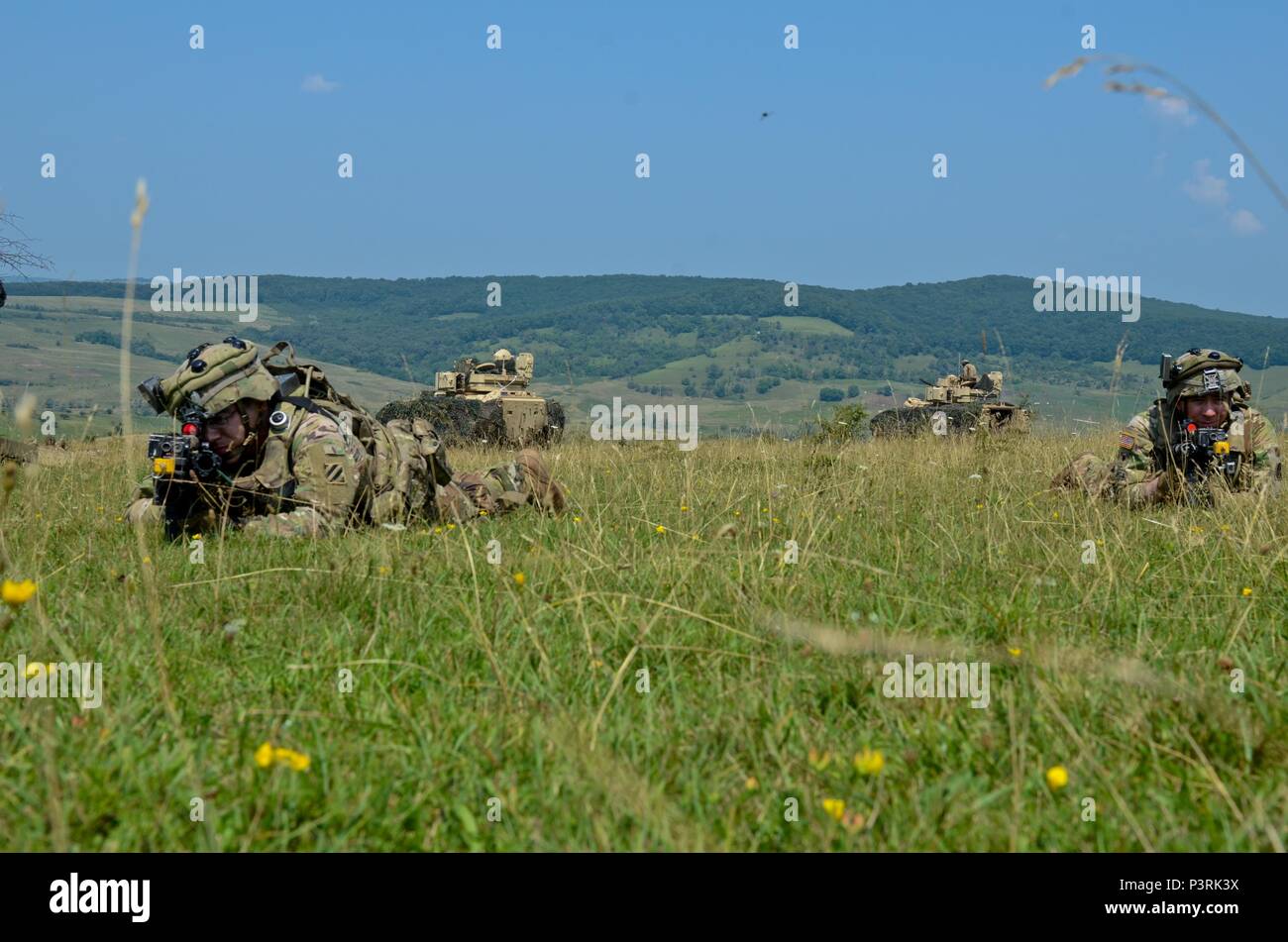 Soldiers with 1st Battalion, 64th Armor Regiment, 1st Armored Brigade Combat Team, 3rd Infantry Division, pull security during exercise Saber Guardian 2016, July 29 at the Romanian Land Forces Combat Training Center in Cincu, Romania. Saber Guardian is a multinational military exercise involving approximately 2,800 military personnel from ten nations including Armenia, Azerbaijan, Bulgaria, Canada, Georgia, Moldova, Poland, Romania, Turkey, Ukraine and the U.S. The objectives of this exercise are to build multinational, regional and joint partnership capacity by enhancing military relationship Stock Photo