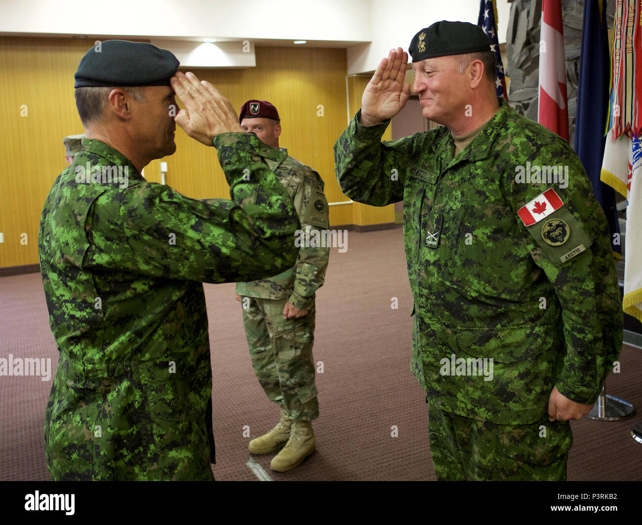 Canadian Army Brig. Gen. Martin Frank (right), U.S. Army Alaska deputy commander - operations, salutes Canadian Army Maj. Gen. J.C.G. Juneau, Canadian Army deputy commander, during the newly minted brigadier general's July 22 promotion at Joint Base Elmendorf-Richardson. Martin will soon take an assignment in Canada. (U.S. Air Force photo by David Bedard) Stock Photo