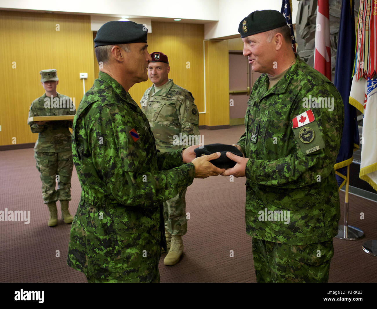 Canadian Army Brig. Gen. Martin Frank (right), U.S. Army Alaska deputy  commander - operations, receives a beret with his new rank insignia from Canadian  Army Maj. Gen. J.C.G. Juneau, Canadian Army deputy