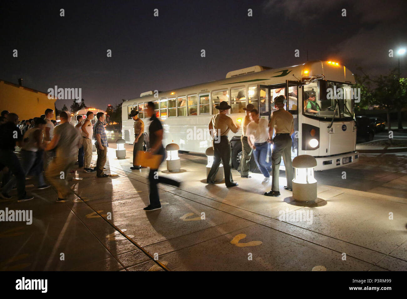 New recruits of Alpha Company, 1st Recruit Training Battalion, are welcomed to the depot as they exit the bus and step onto the yellow footprints during receiving at Marine Corps Recruit Depot San Diego, May 8. From this point on, recruits will eat, sleep and train as a team as they begin the transformation from civilian to Marine. Annually, more than 17,000 males recruited from the Western Recruiting Region are trained at MCRD San Diego. Alpha Company is scheduled to graduate Aug. 4. Stock Photo