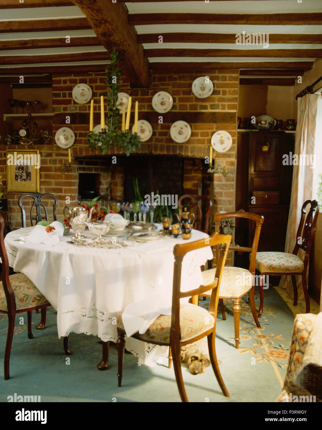 Ivy decorated metal candelabra above circular table with crisp white