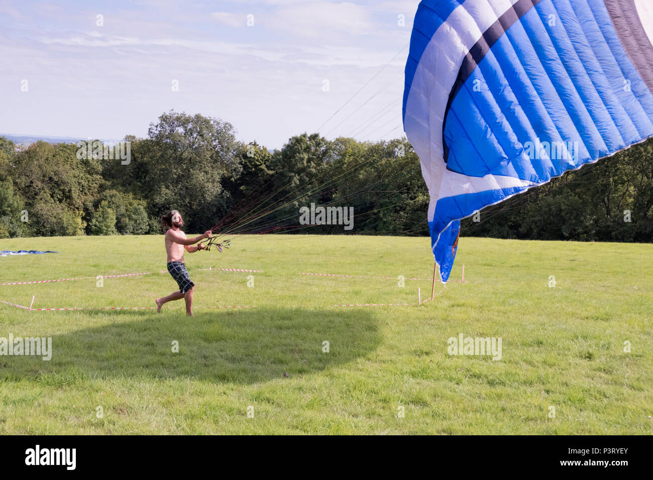 Chepstow, Wales – Aug 14: Man launching a paraglider on 14 Aug 2016 at the Green Gathering Festival site Stock Photo
