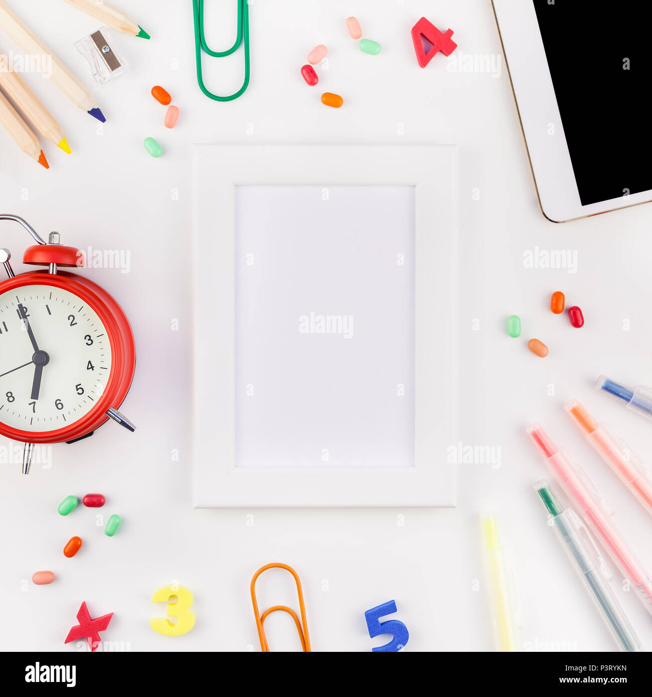 Square flat lay back to school concept blank tablet with alarm clock ...