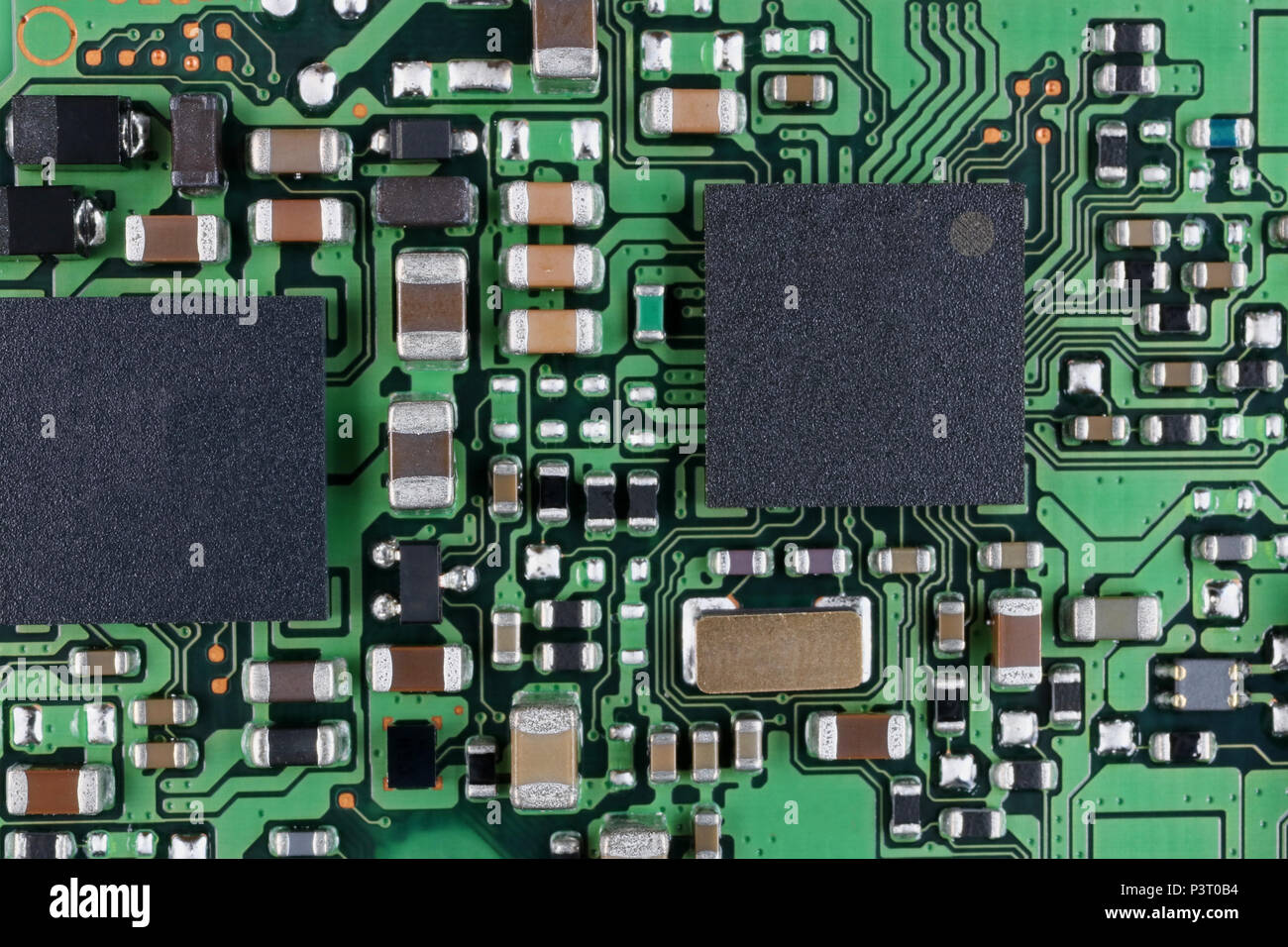 Microchips and microcircuits with ball pins are installed on a modern electronic circuit board background.  SUper macro studio  techno concept Stock Photo