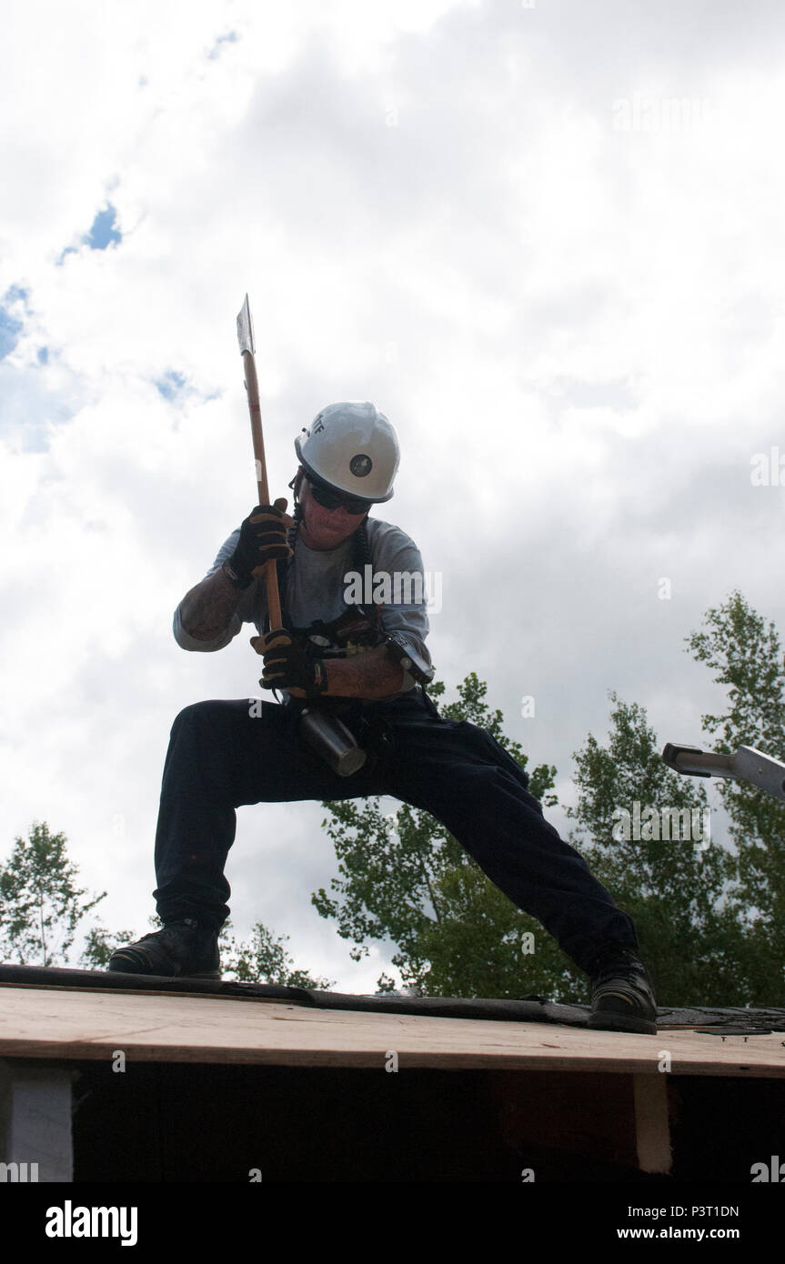 A rescue specialist from a Federal Emergency Management Agency task force  breaches the rooftop of a semisubmerged building during Vigilant Guard  2016 at Camp Ethan Allen Training Site, Jericho, Vermont. Vigilant Guard
