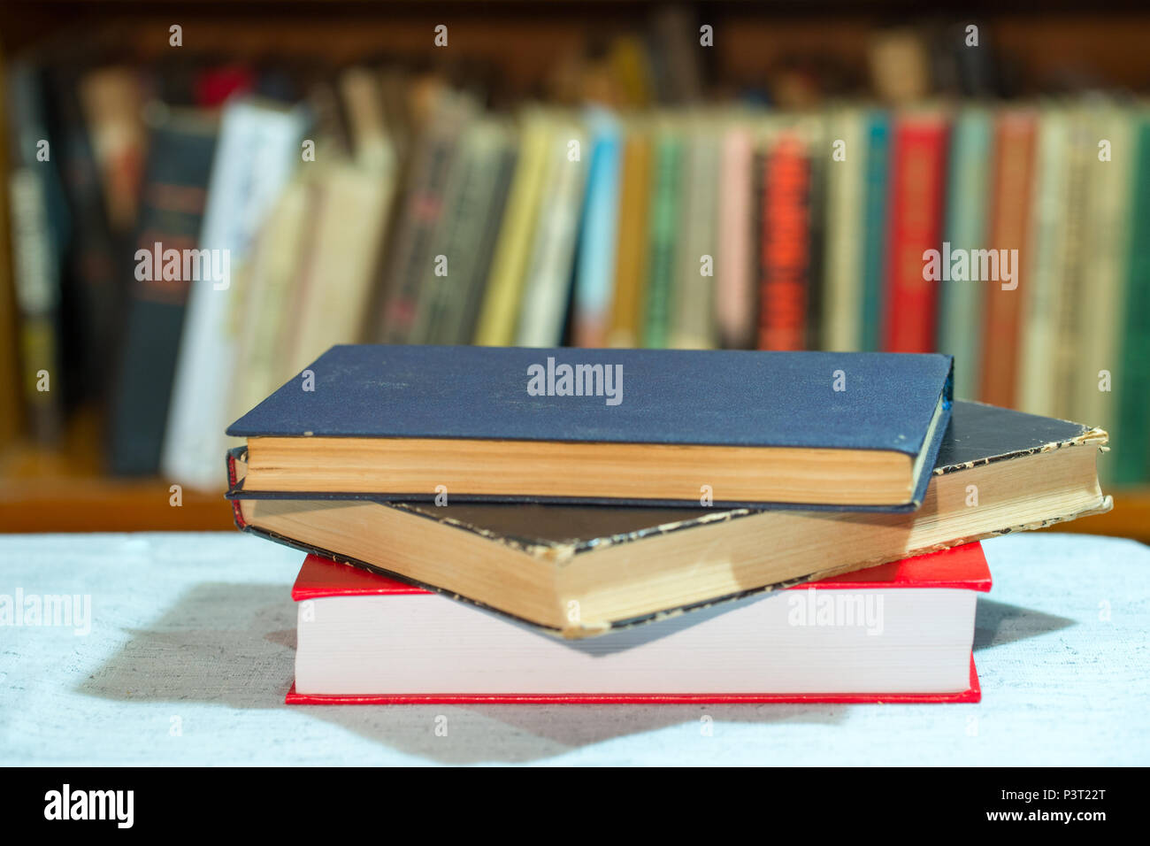 Book, stack of hardback books on table. Top view Stock Photo - Alamy