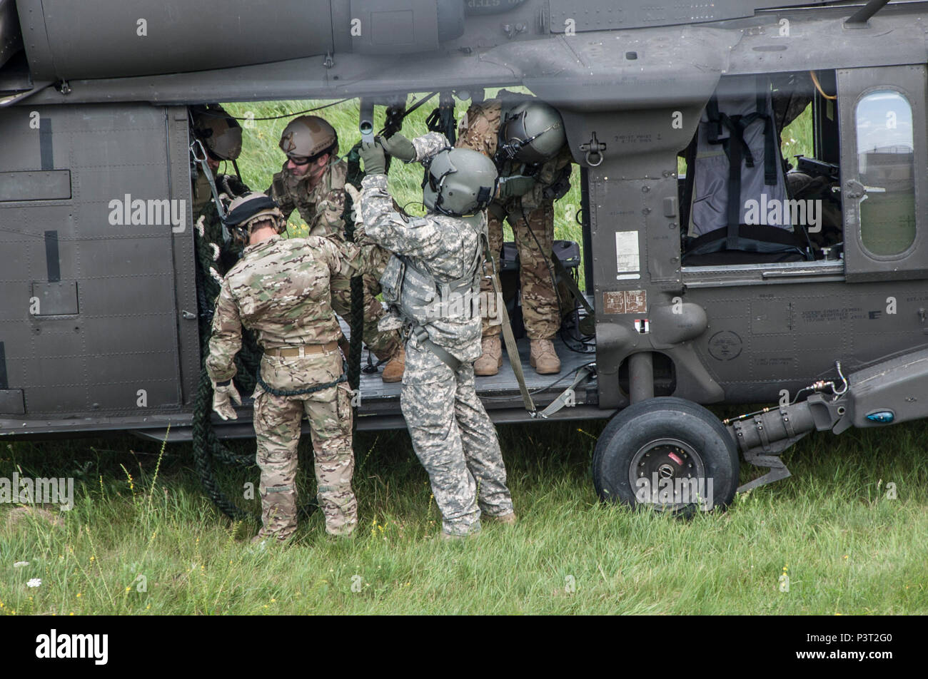 The crew of a UH-60 Black Hawk prepares a rope as Army National Guard ...