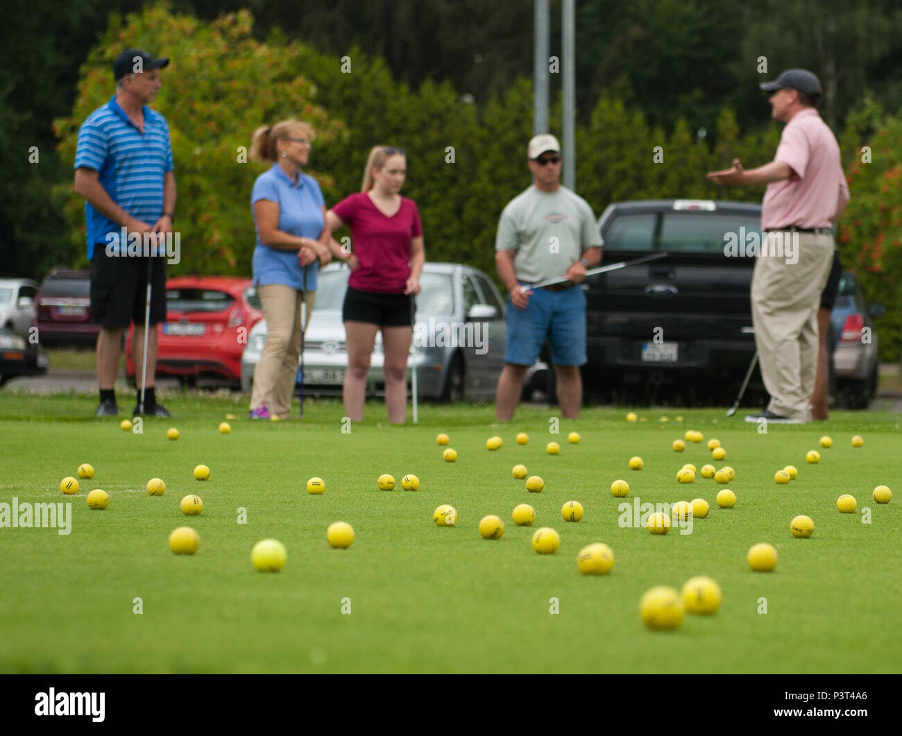 Participants of a Woodlawn Golf Course class listen to Kevin O'Connor,  Professional Golfers' Association of America teaching professional, July  28, 2016, at Ramstein Air Base, Germany. Available to Kaiserslautern  Military Community members