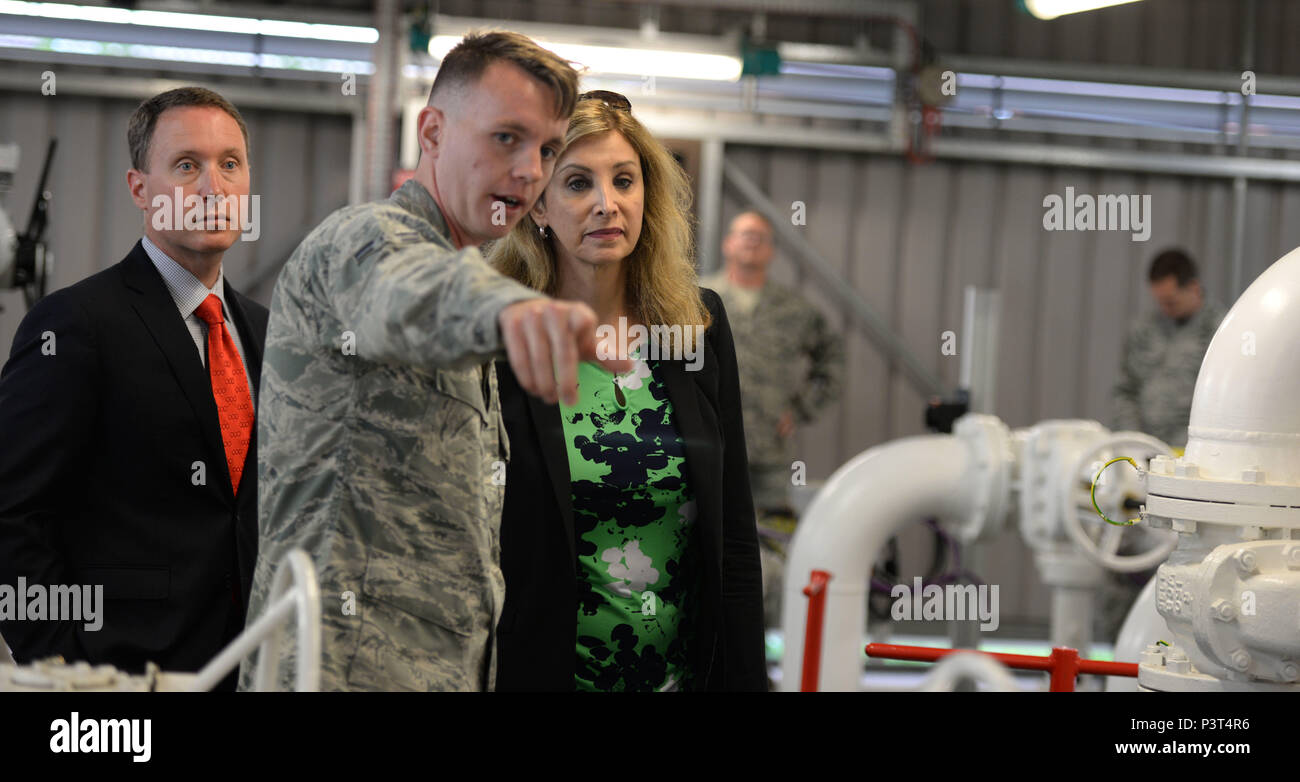 U.S. Air Force Airman 1st Class George Palmer, center, 100th Logistics Readiness Squadron fixed facility operator, shows Amanda Simpson, right, Deputy Assistant Secretary of Defense for Operational Energy, and Robert Warshel, left, Director of Operations, Operational Energy Plans and Programs, the North Tank fuel storage unit July 29, 2016, on RAF Mildenhall, England. During the tour of the base, Simpson and Warshel spoke with Airmen and learned about their mission. (U.S. Air Force photo by Gina Randall) Stock Photo