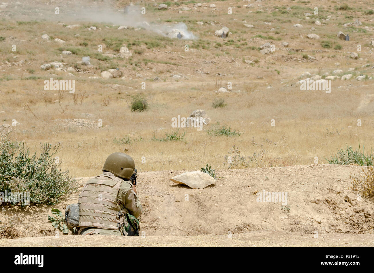 A Peshmerga soldier fires his M16 rifle at targets down range while ...
