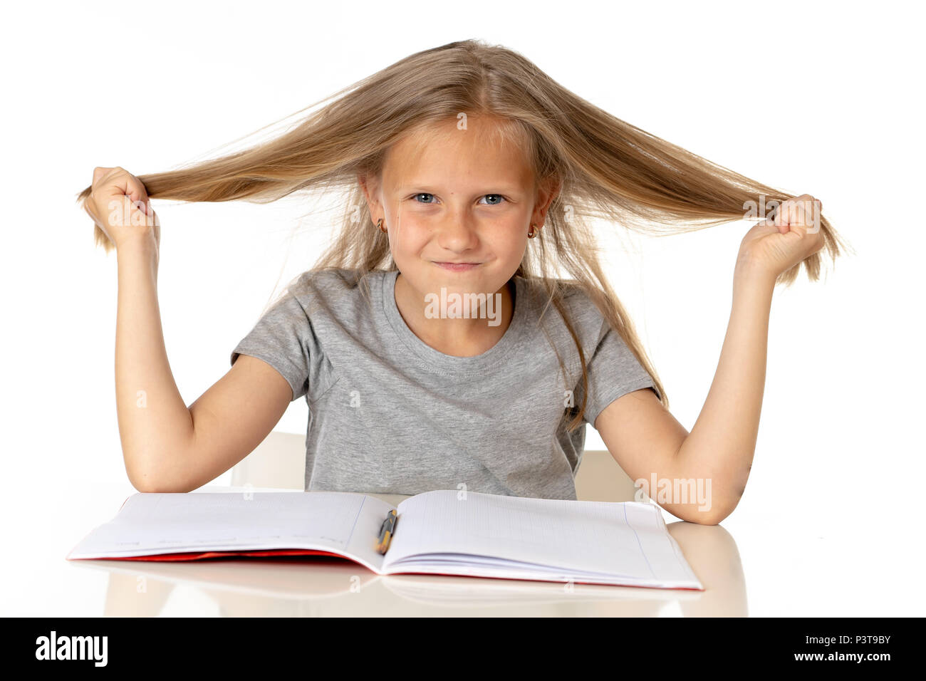 sweet young little schoolgirl pulling her hair desperate in stress