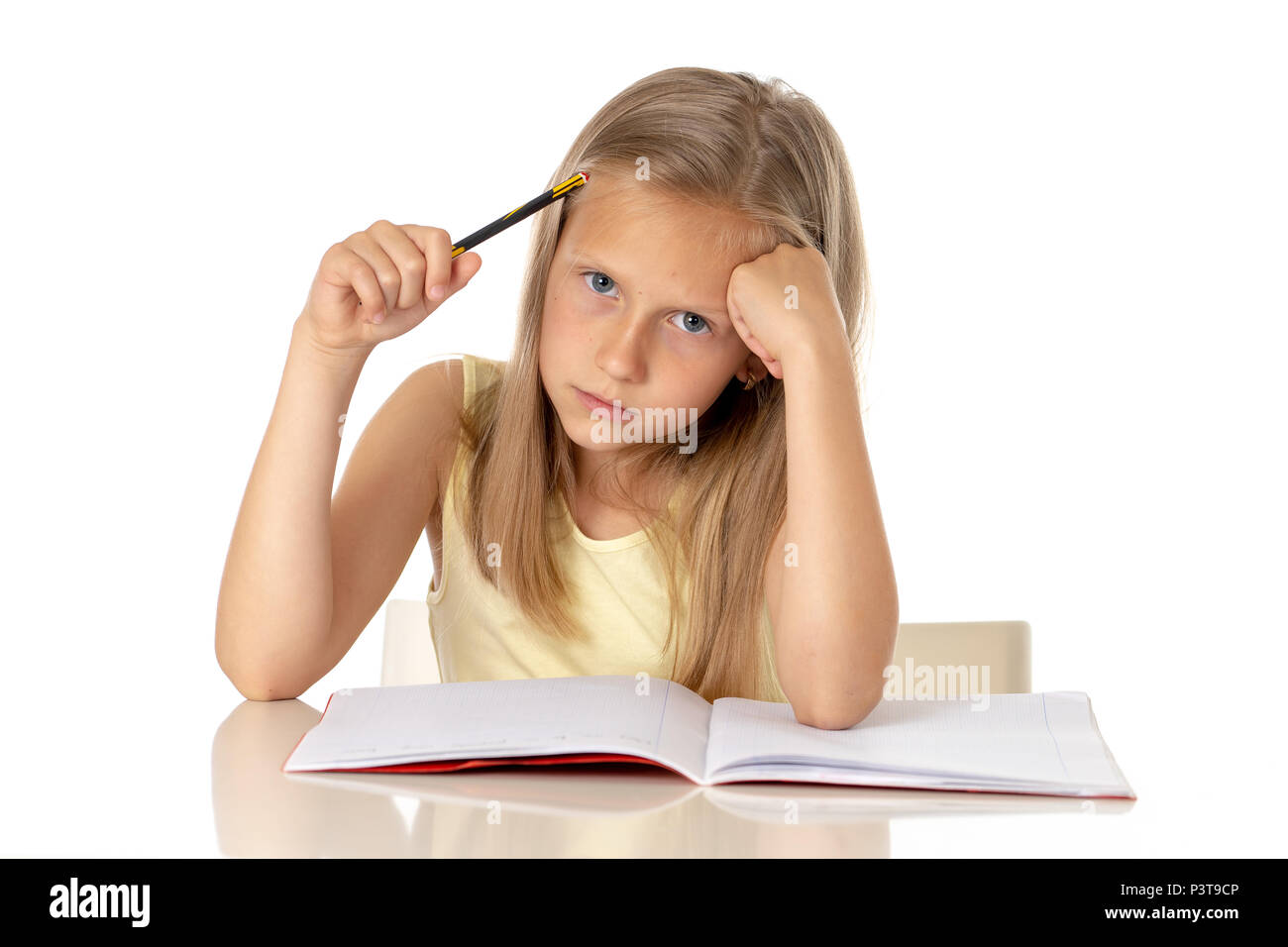 education, elementary school, childhood and emotions concept sad or bored little student girl studying looking frustrated with learning problems on wh Stock Photo