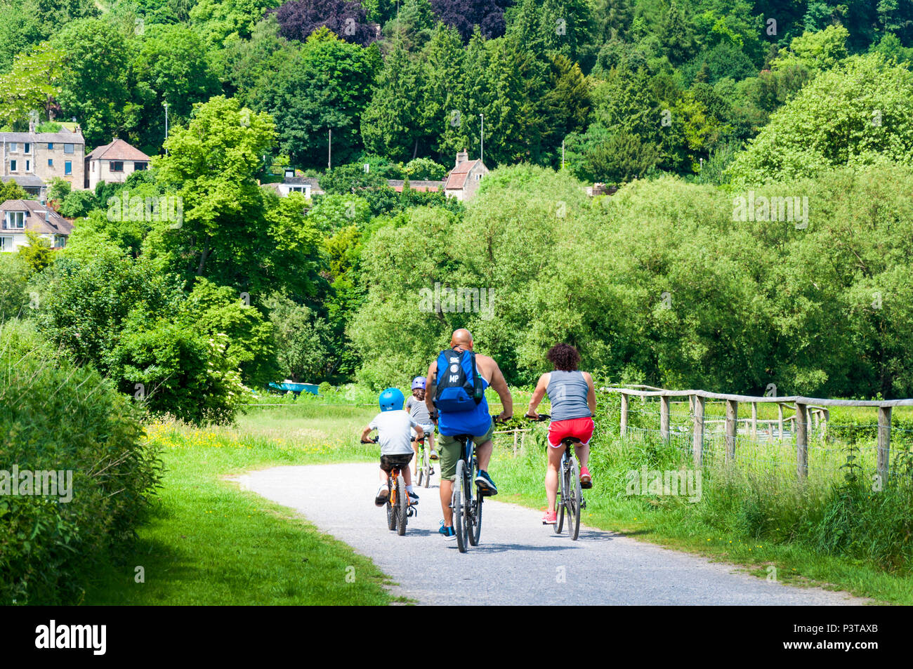 Family cycling on River Avon pathway at Bathampton, Somerset, UK Stock Photo