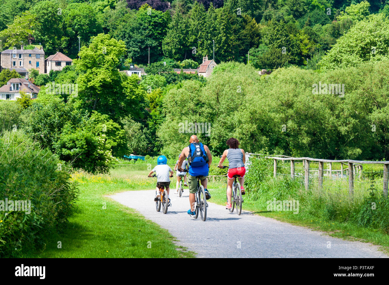Family cycling on River Avon pathway at Bathampton, Somerset, UK Stock Photo