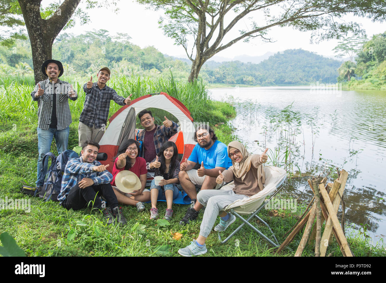 people camping showing thumb up Stock Photo