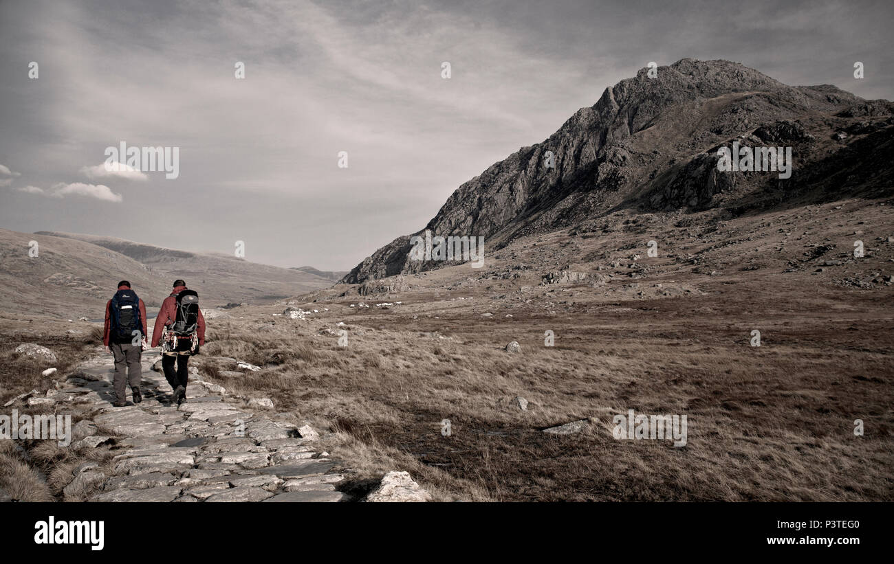 Two men hiking past Tryfan mountain in Snowdonia, North Wales Stock Photo