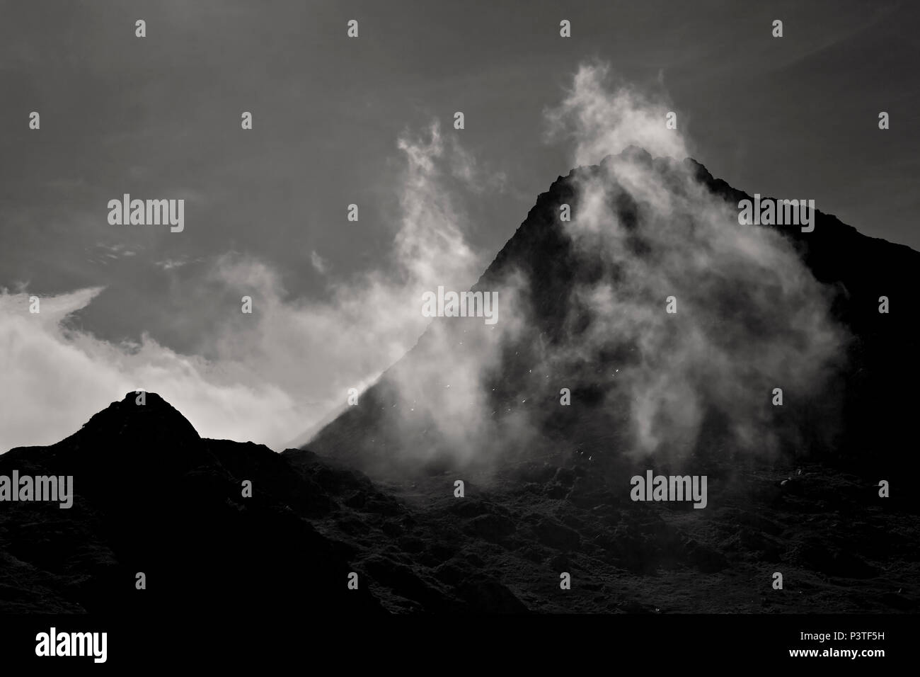 Mist over the summit of Tryfan mountain in the Glyderau range, Snowdonia, North Wales Stock Photo