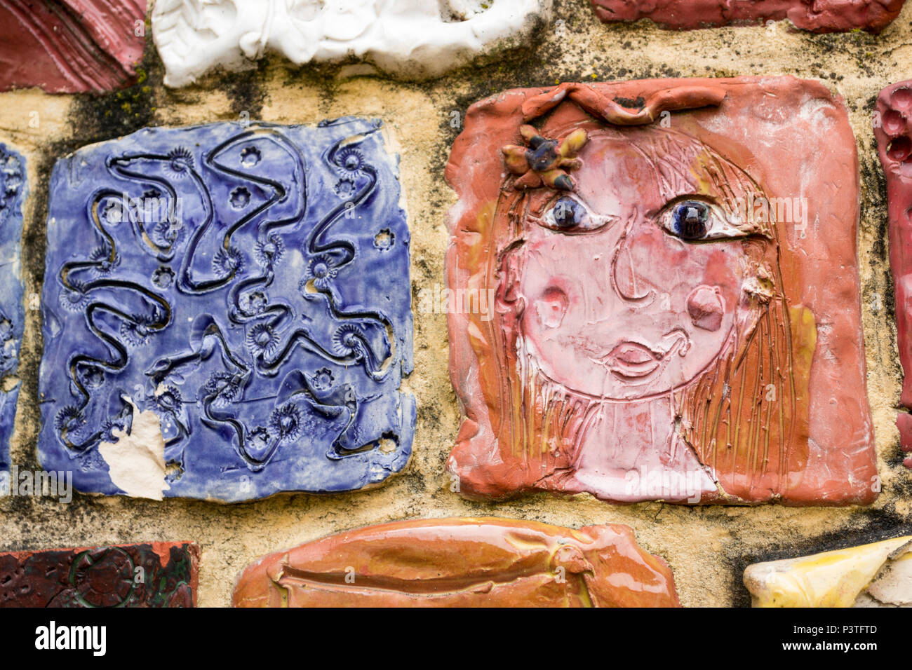 Mosiac of handmade ceramic tiles of showing a girl's face at Evreux, Normandy, France Stock Photo