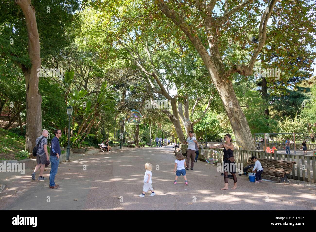 Family playing in Jardim da Estrela, Barrio Alto, Lisbon, Portugal Stock Photo