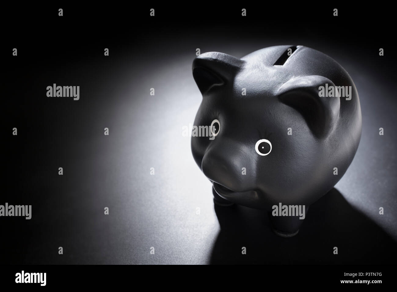 Black piggy bank on blackboard background Stock Photo