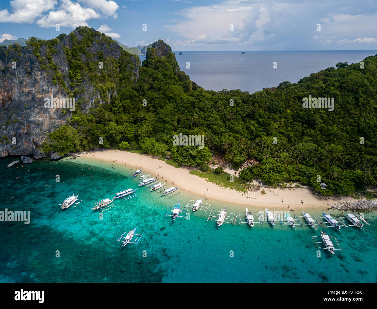 Aerial drone view of a beautiful tropical island and sandy beach surrounded by coral reef (Dilumacad Island) Stock Photo