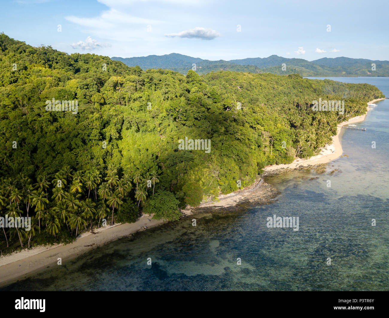 Aerial drone view of a beautiful tropical bay with reef, sandy beach and jungle scenery Stock Photo