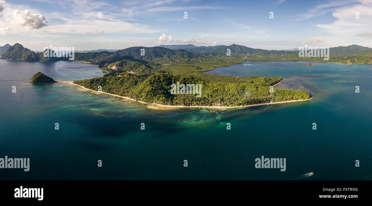 Aerial drone panoramic view of a beautiful tropical beach and reef in the evening (Las Cabanas, Palawan) Stock Photo
