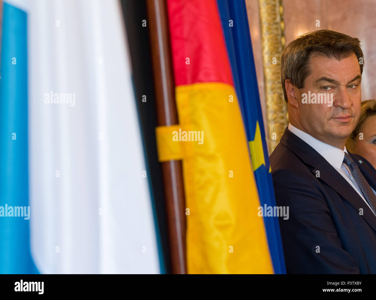 19 June 2018, Germany, Munich: Markus Soeder of the Christian Social Union (CSU), Premier of Bavaria, stands next to the Bavarian, German and European flag during the signing of the certificates of the 'Pakt fuer berufliche Weiterbildung 4.0' (lit. Pact for professional development 4.0). Photo: Peter Kneffel/dpa Stock Photo