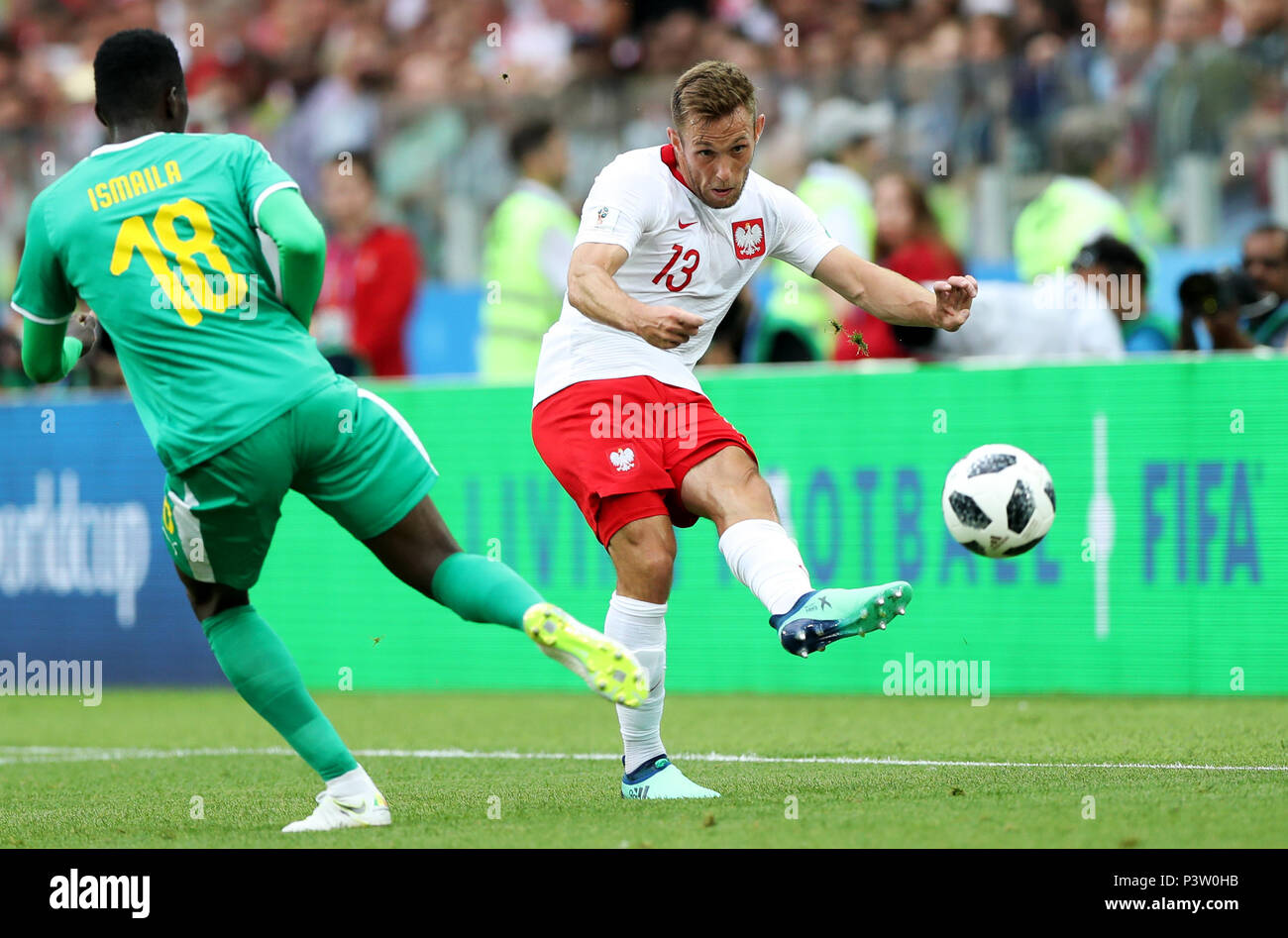 Moscow, Russia. 19th June, 2018. Maciej Rybus (R) of Poland passes the ball during a Group H match between Poland and Senegal at the 2018 FIFA World Cup in Moscow, Russia, June 19, 2018. Credit: Xu Zijian/Xinhua/Alamy Live News Stock Photo