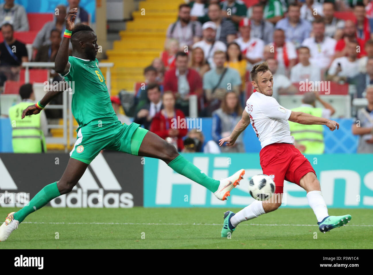 Moscow, Russia. 19th June, 2018. Maciej Rybus (R) of Poland vies with Salif Sane of Senegal during a Group H match between Poland and Senegal at the 2018 FIFA World Cup in Moscow, Russia, June 19, 2018. Senegal won 2-1. Credit: Ye Pingfan/Xinhua/Alamy Live News Stock Photo