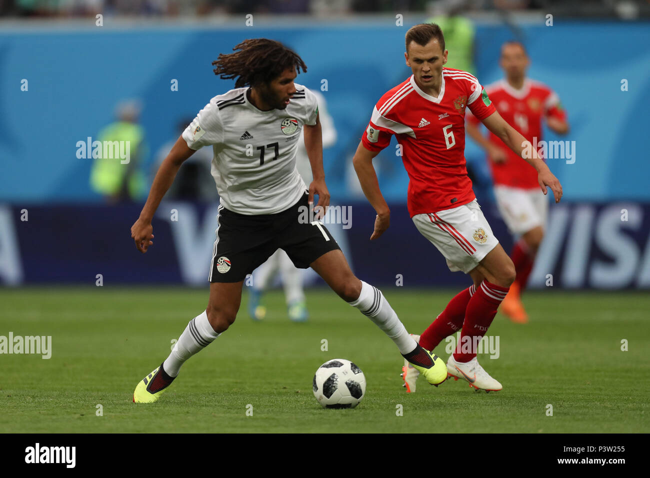 Egypt's  Mohamed Elneny (L) vies for the ball with Russia's Denis Cheryshev during the FIFA World Cup 2018 Group A soccer match between Egypt and Russia, at the Saint Petersburg Stadium, in Saint Petersburg, Russia, 19 June 2018. Photo: Ahmed Ramadan/dpa Stock Photo