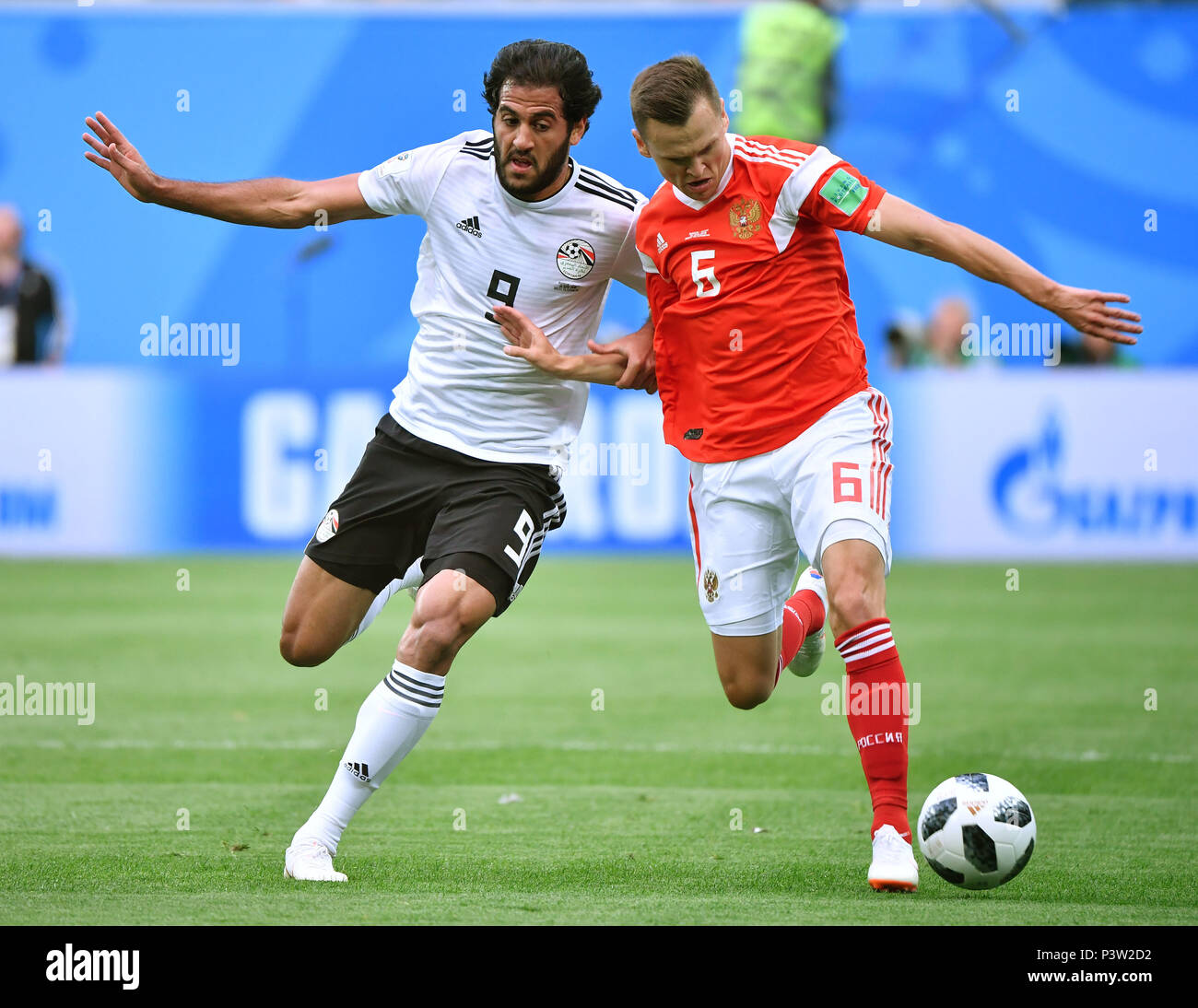 Saint Petersburg, Russia. 19th June, 2018. Denis Cheryshev (R) of Russia vies with Marwan Mohsen of Egypt during a Group A match between Russia and Egypt at the 2018 FIFA World Cup in Saint Petersburg, Russia, June 19, 2018. Credit: Li Ga/Xinhua/Alamy Live News Stock Photo