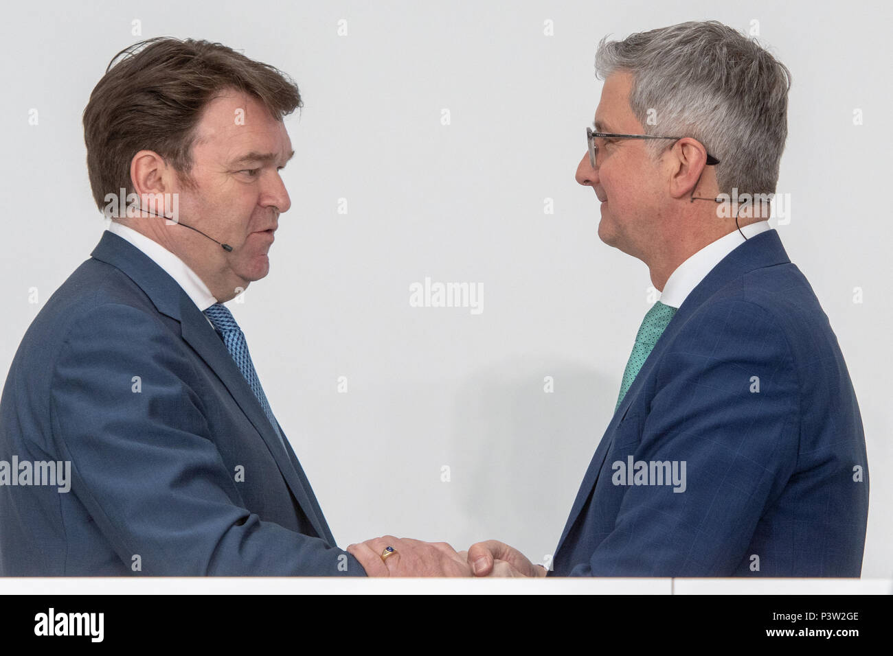 Ingolstadt, Germany. 15th Mar, 2018. Bram Schot (L), Audi sales director, and Rupert Stadler, now suspended CEO of automobile manufacturer Audi AG, shake hands after the financial statement press conference. Audi sales director Schot takes over the directorial position temporarily at the car manufacturer on 19 June 2018. Credit: Armin Weigel/dpa/Alamy Live News Stock Photo